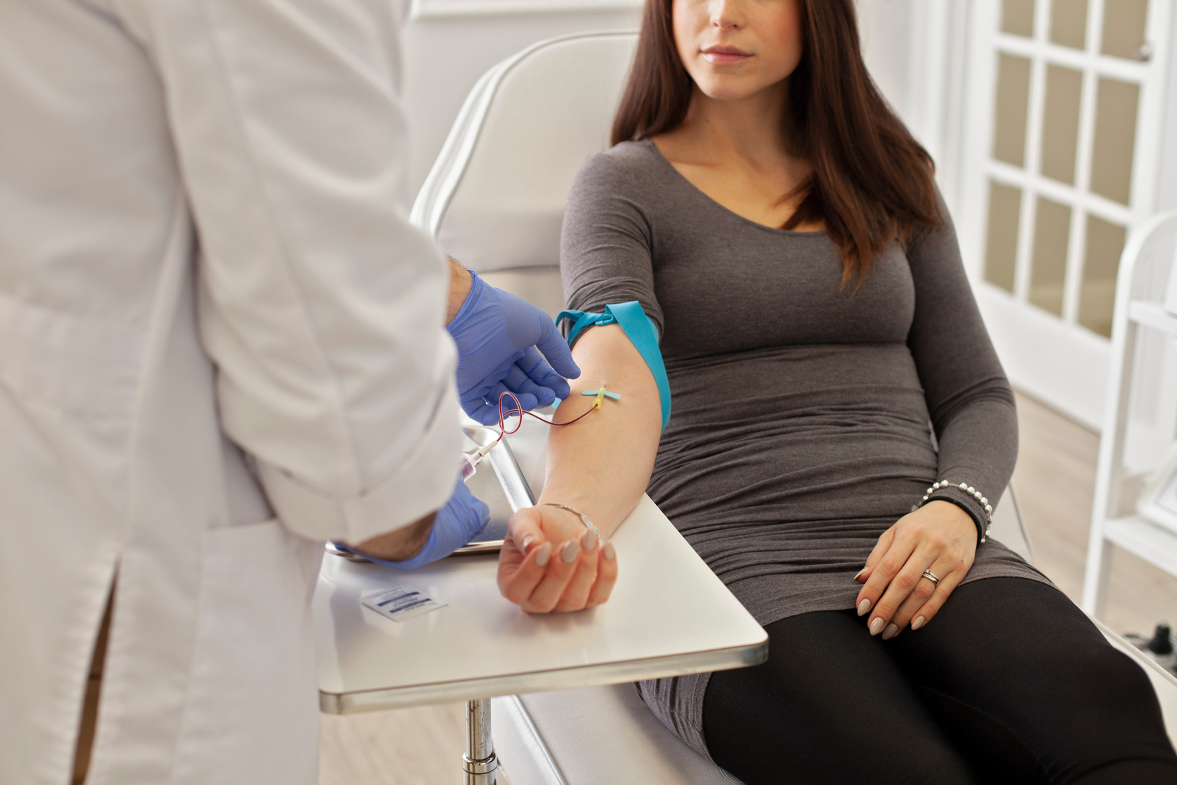 Woman is seated getting blood drawn for labwork. This is similar to the experience patients will have at Grace Healthcare and Urgent Care clinic in Raeford, NC. 